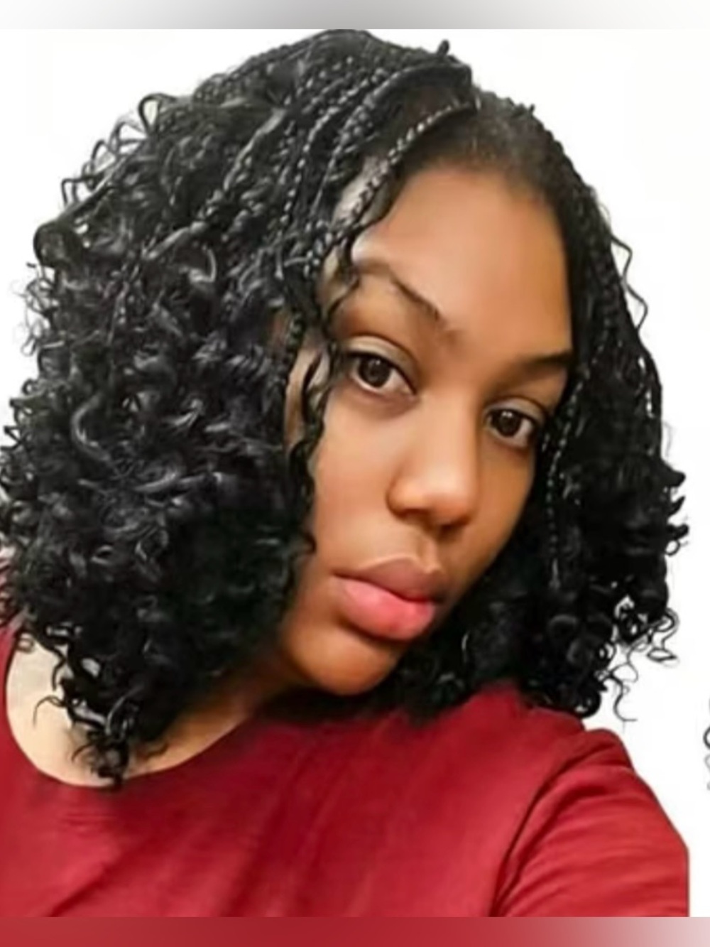 Boho knotless braids with loose, voluminous curls in a bob length